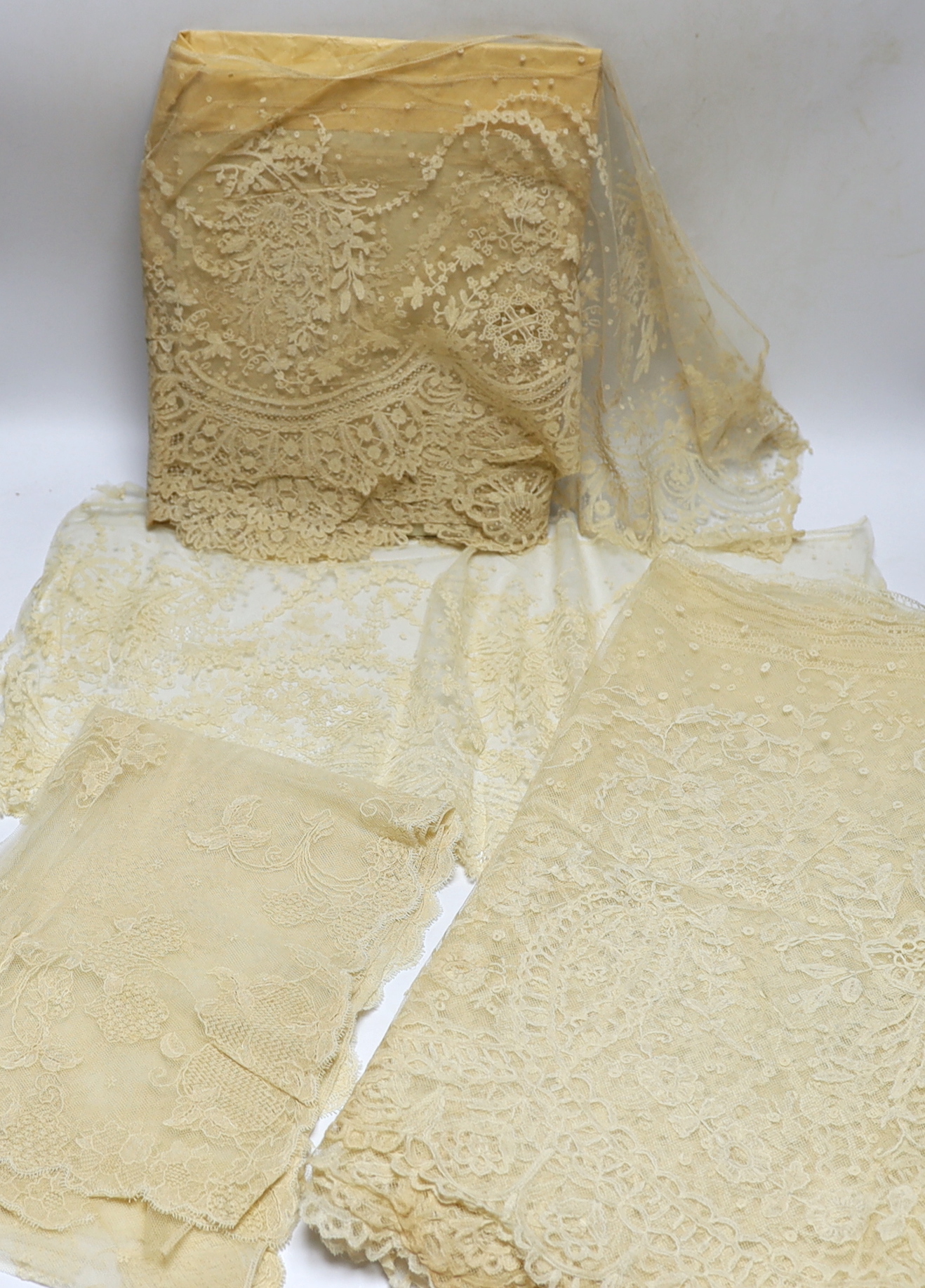 Late 19th century bobbin lace trimming: a length of mixed Brussels bobbin and needle lace trim, 255cm x 30cm and another length in the same design 126cm x 30cm together with a Honiton bobbin lace length 460cm x 50cm and